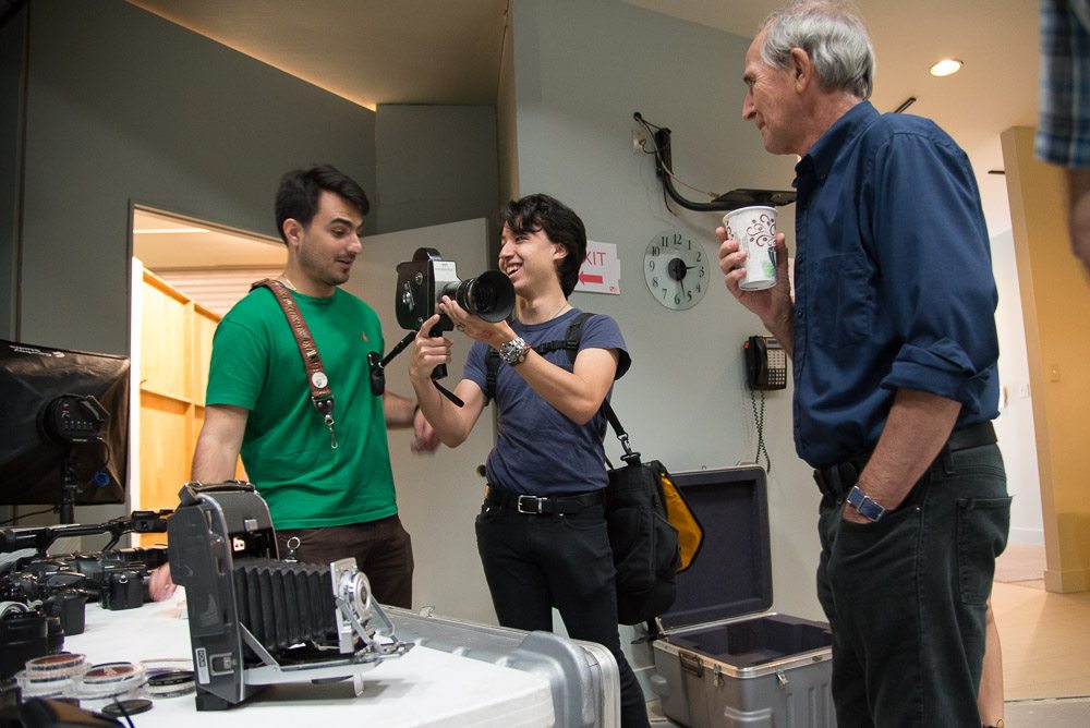 people looking at vintage camera equipment